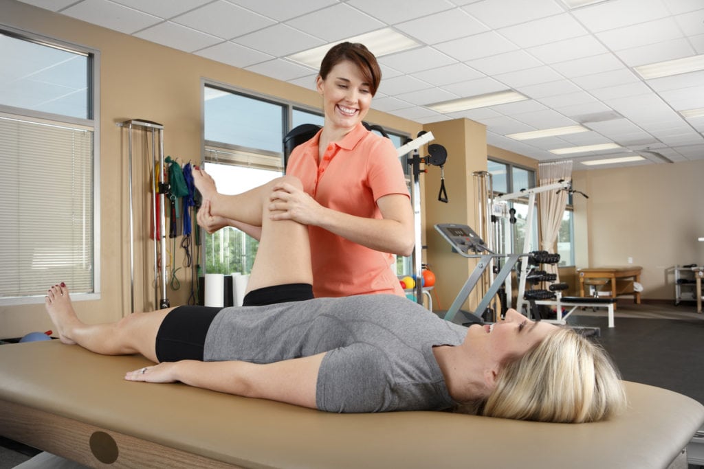 Physical therapist and patient in physical therapy clinic