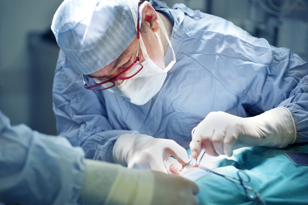 surgeons operating hand surgery