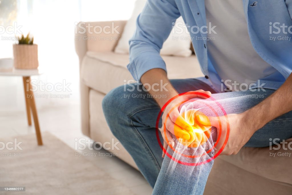 Man Suffering from Knee Pain At Home