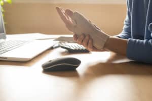 A man wearing a wrist brace for Injury recovery and carpal tunnel syndrome relief.