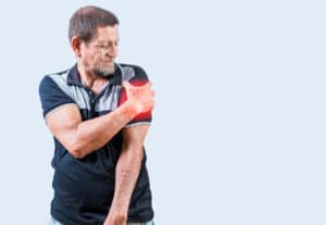 An elderly person is experiencing arm pain due to a rotator cuff tear.