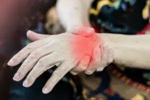 Chronic pain in the wrist of an elderly woman due to Carpal Tunnel Syndrome (CTS).
