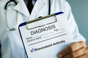 A rheumatoid arthritis doctor holding clipboard with diagnosis rheumatoid arthritis.